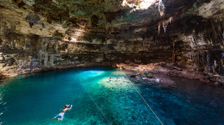 Swimmers cool of in one of Cancun's 30,000 cenote natural sinkholes