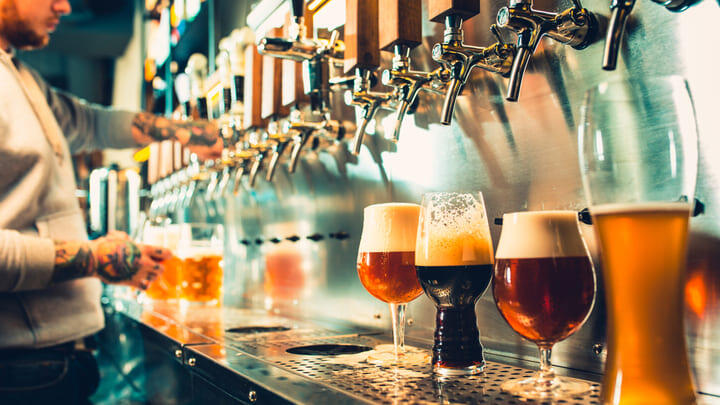 Barman pouring several different types of craft beer