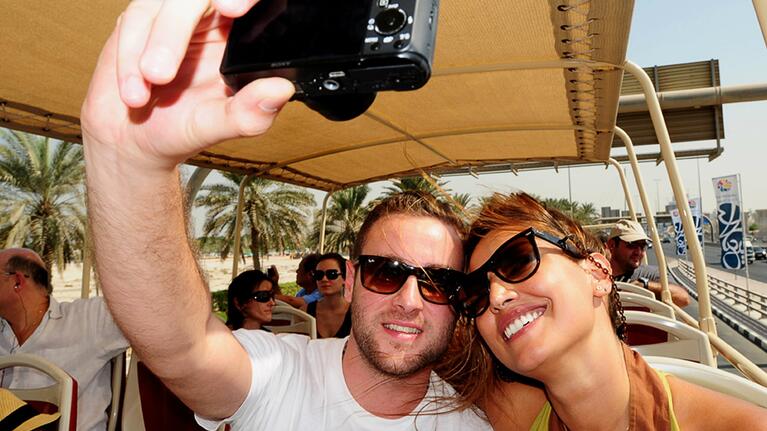 A couple enjoying Dubai's Hop-on Hop-off sightseeing bus