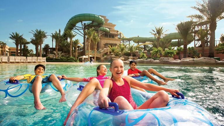 Children on inflatables drifting along Aquaventure's lazy river