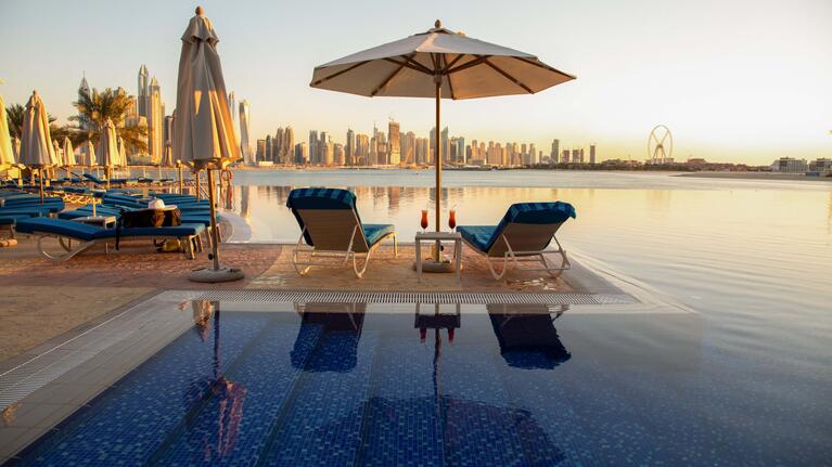 Sun loungers sitting empty on a Dubai rooftop terrace