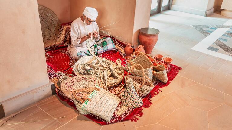 A man weaves handicrafts in Dubai