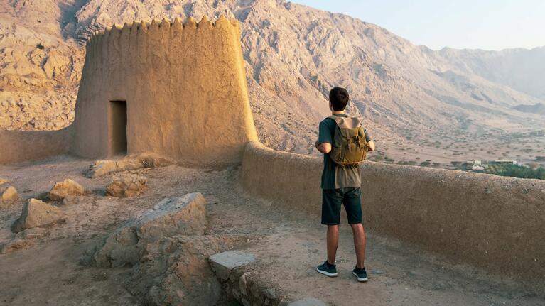 A tourist exploring a historic fort in Dubai
