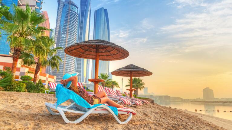 A beach with sun loungers and umbrellas in Dubai