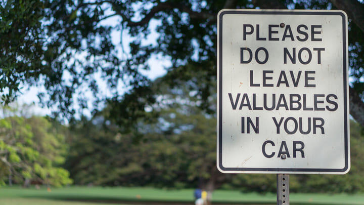 Park sign warning drivers not to leave valuables in their cars.