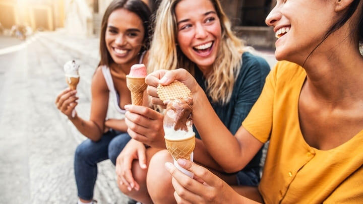 Women chatting over gelato-filled cones in Rome