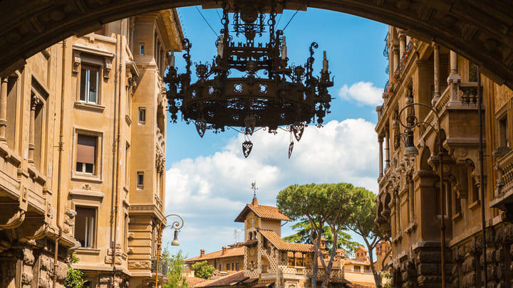 Archway with decorative iron chandelier at the entrance to the Quartiere Coppedè neighborhood