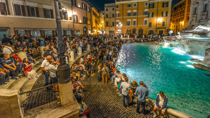 Hundreds of revelers crowded around Trevi Fountain at night