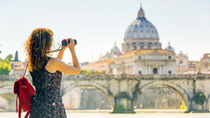 Female tourist taking photos of St Paul's Cathedral from afar