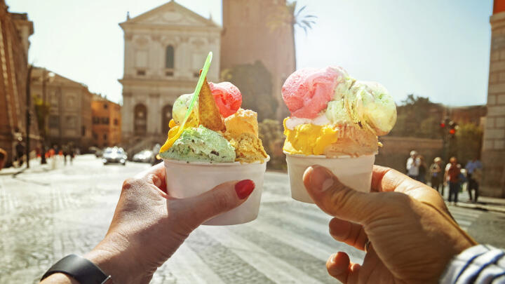 Couple holding gelato tubs on Rome streets