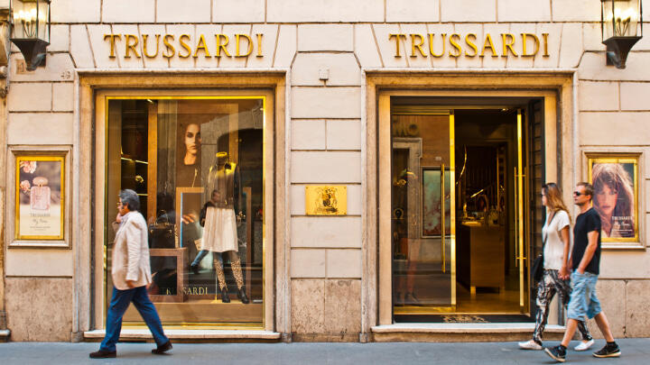 Pedestrians waking by Trussardi outlet