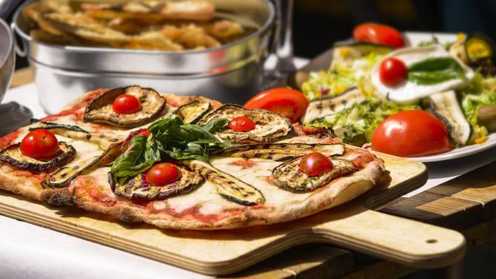 Typical Italian pizza with tomato and zucchini