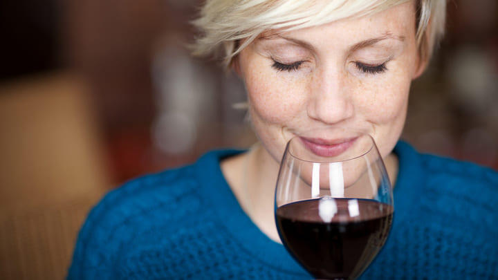 Woman enjoying the bouquet from a glass of red wine