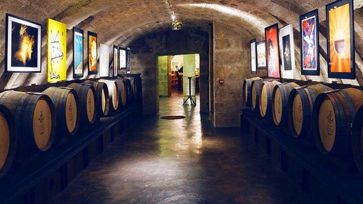 Two rows of barrels in Caves du Louve wine cellar