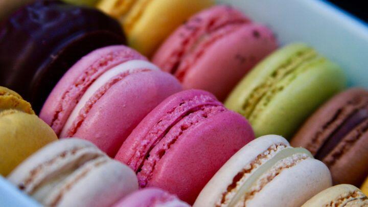 Close up of pink, green and other macarons packed in a box