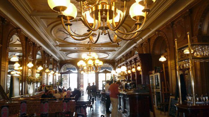 Ornate chandelier, brass and wood interior of Cafe de la Paix, Paris
