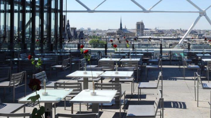 Restaurant tables on sunny terrace overlooking Paris at George restaurant, Centre Pompidou
