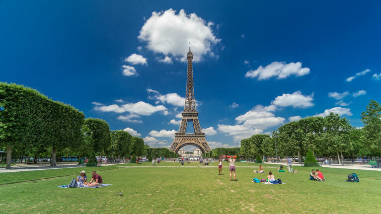 Picnickers enjoy views of the Eiffel Tower from the Champ de Mars
