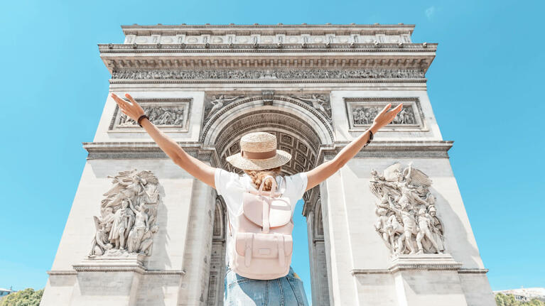 A tourist admires the Arc du Triomphe