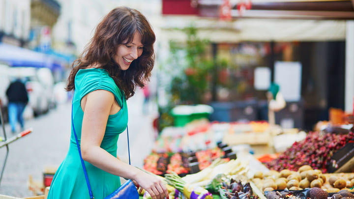 A woman shopping for fresh produce at a Paris market