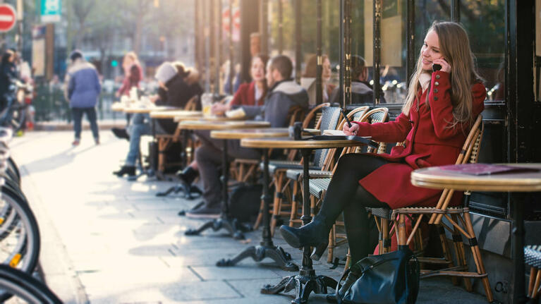 Parisians sitting at exterior cafe tables
