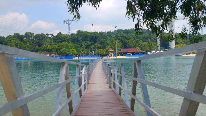 Looking along the bridge towards the beaches, cabins and forest of Sentosa Island