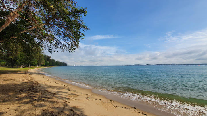 Tranquil beach scene at Changi Beach Park in Singapore.
