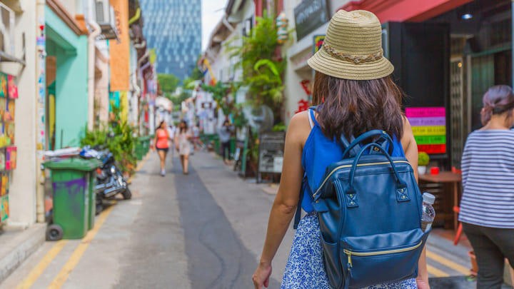 A tourist exploring vibrant Haji Lane in Kampong Glam.