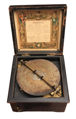 Antique music box with a copper disc
