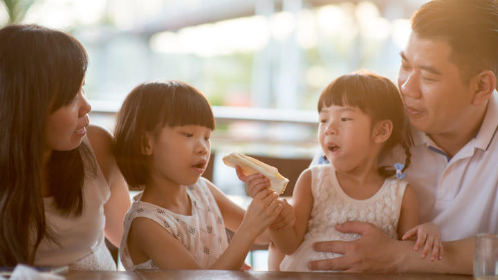 Young family eating lunch together