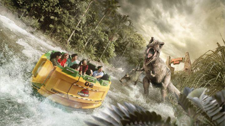 T-rex wading into water roaring at surprised group of people in yellow rapids ride boat
