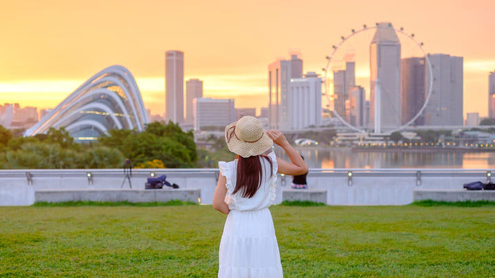 Woman looking across the water to the Singapore Flyer