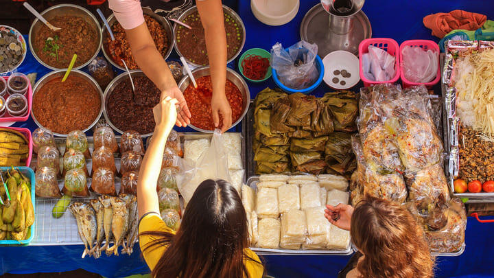 Hungry customers at a food market in Bangkok