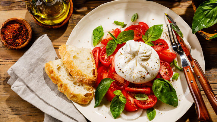 Burrata with tomatoes, basil and bread.