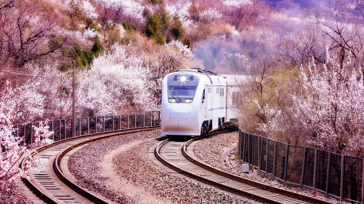 Train traveling through picturesque landscape in China.