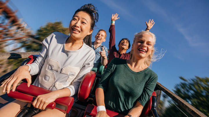 Friends having fun on a rollercoaster.