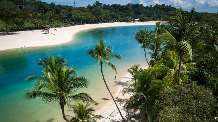 The palm-lined white sands of Siloso Beach on Singapore's Sentosa island