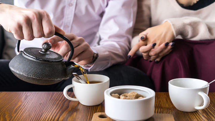 People pouring tea
