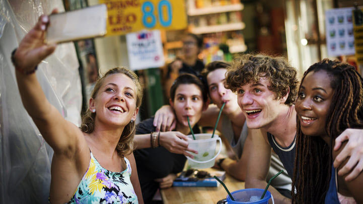 Revelers with bucket drinks on Khaosan Road, Bangkok.