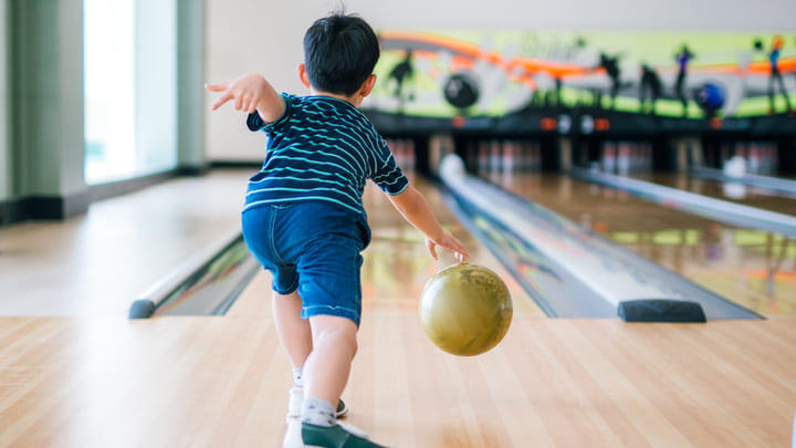 Child at a ten-pin bowling alley.