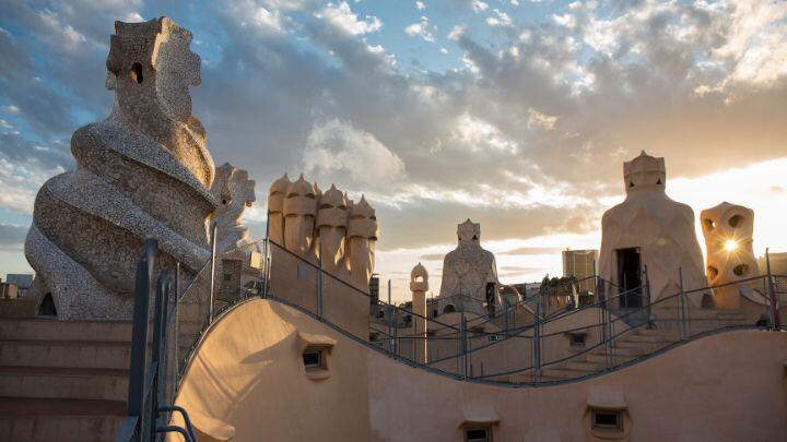 Evening clouds gather over the curved lines and warrior chimneys of La Pedrera Barcelona