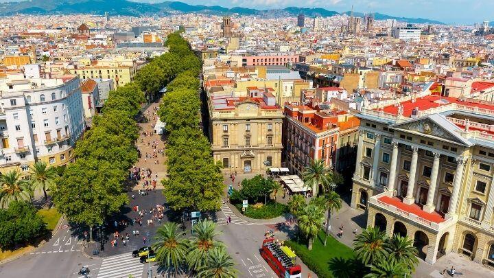 Aerial view of La Rambla and city of Barcelona with distant mountains