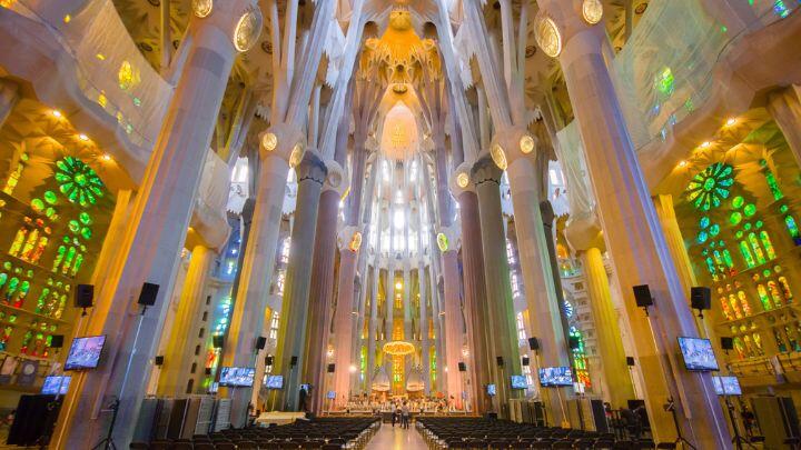 Stained glass windows and towering pillars in interior of Sagrada Familia
