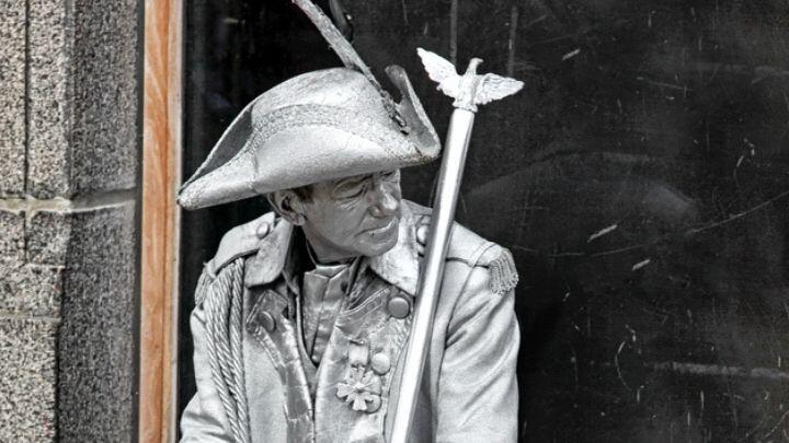 Silver painted living statue performer with hat