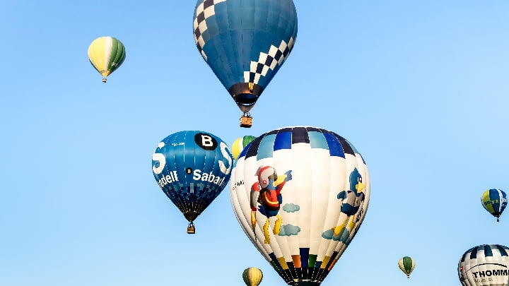Various hot air balloons rising into the air