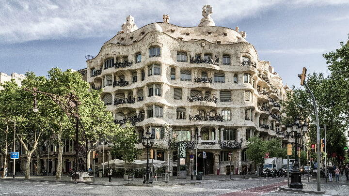 The rough-hewn façade of La Pedrera on the street corner