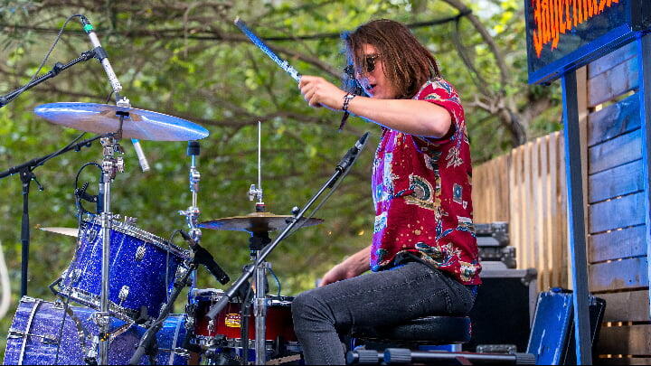 A drummer performing at an outdoor concert in Barcelona
