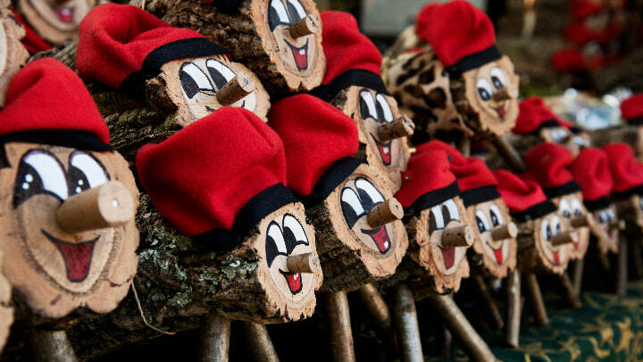 A collection of Tió de Nadal logs on display at a market stall