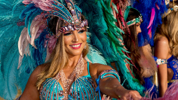 A woman dressed up with feathers, sequins and lace for Carnival