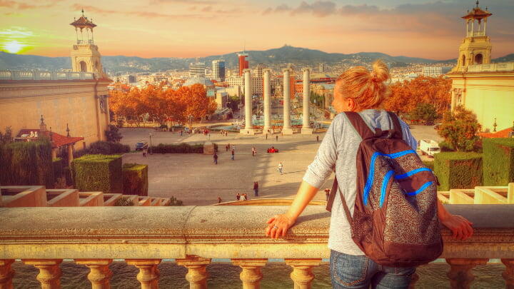 A female tourist looking over a balcony at Plaça d'Espanya